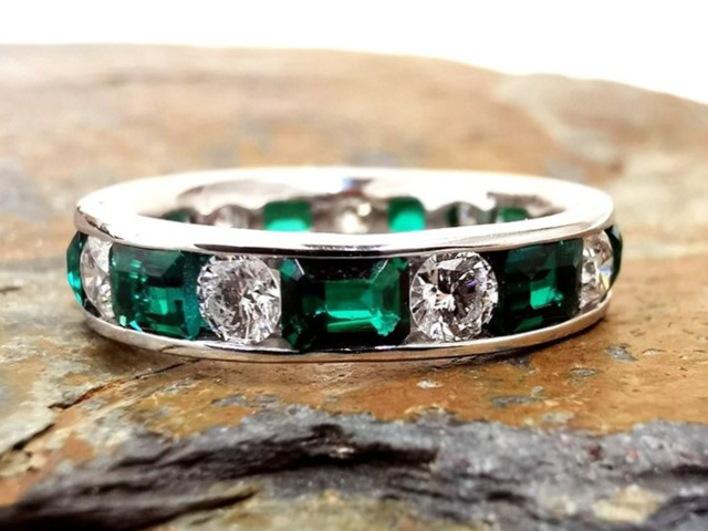 Emerald and diamond set eternity ring
